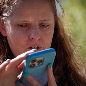 A blind woman uses an iPhone